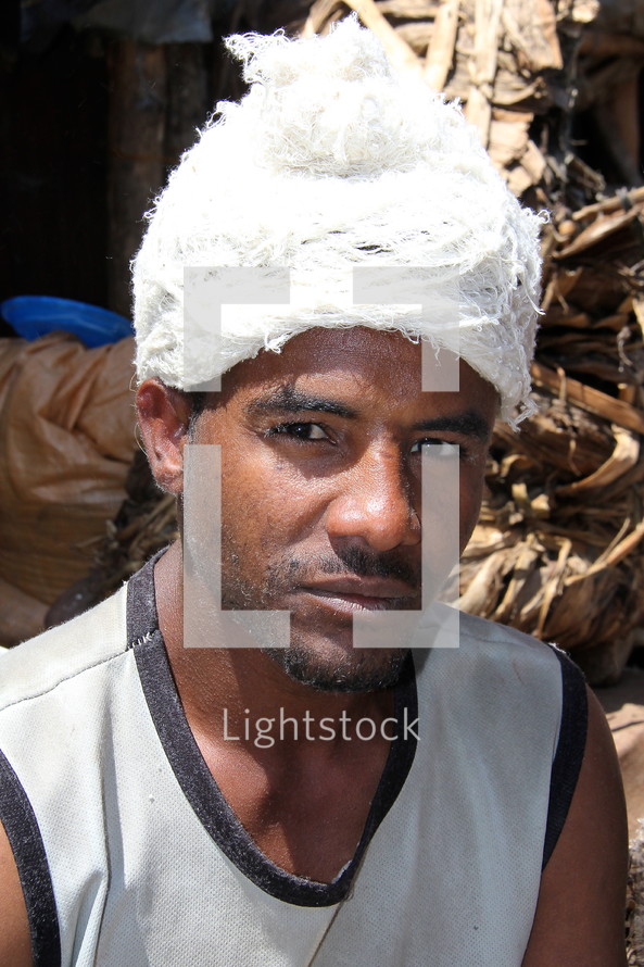 An Ethiopian man working in a cotton mill  [For similar search for Ethnic Face Smile]