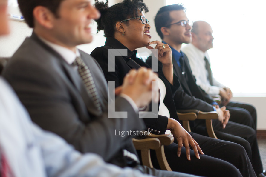 men and women listening to a business meeting 