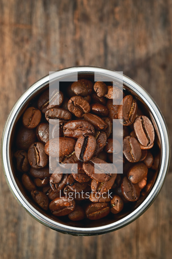 Closeup of roasted coffee beans in coffee machine filter