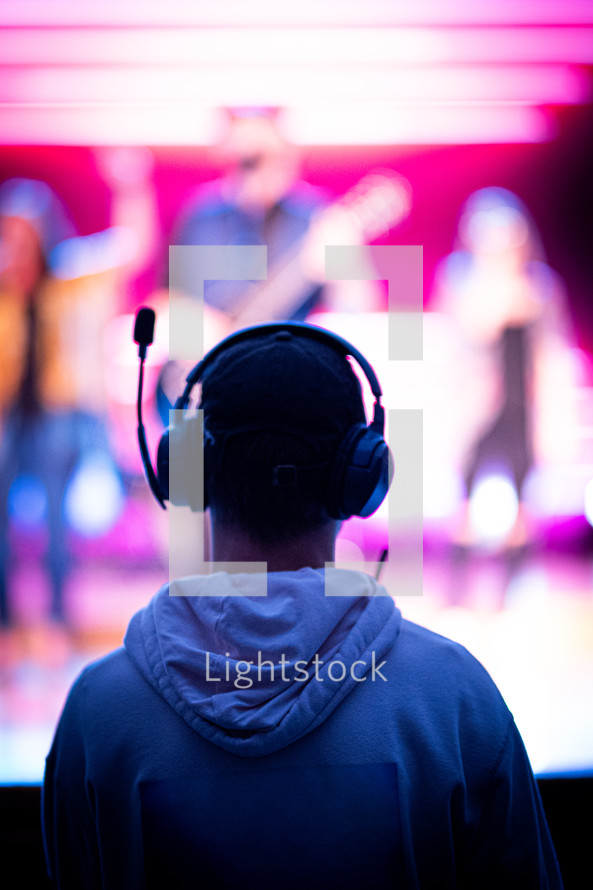 a man with headphones watching a worship service 