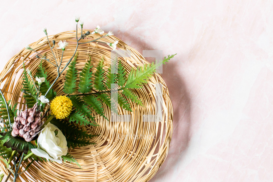 flowers and ferns in a basket 