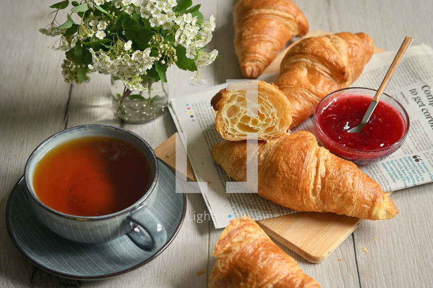 Closeup Table with Fresh baked croissant and tea