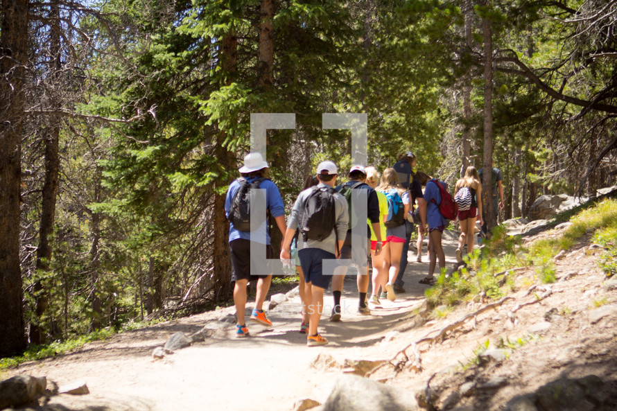 a group of people hiking on a trail 
