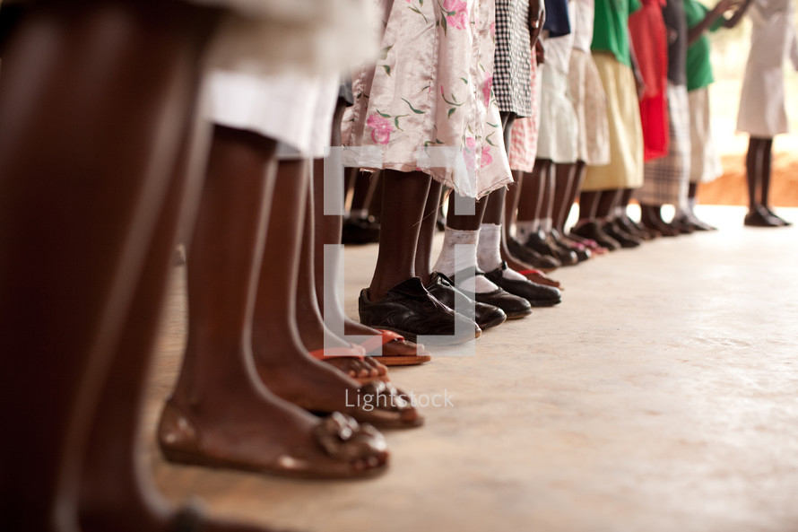 children feet standing in a row 