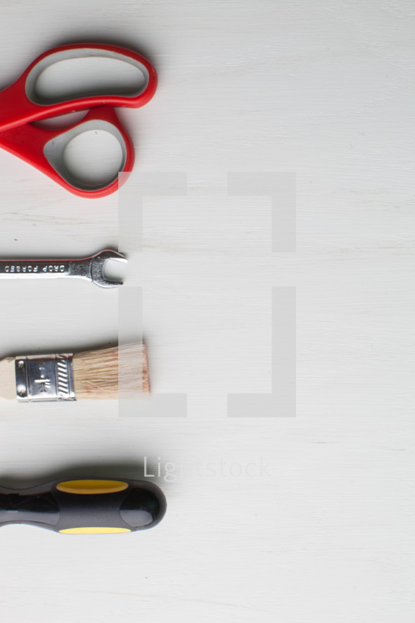 Tools lined up on the left side of a white background.