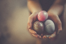hands full of dyed Easter eggs