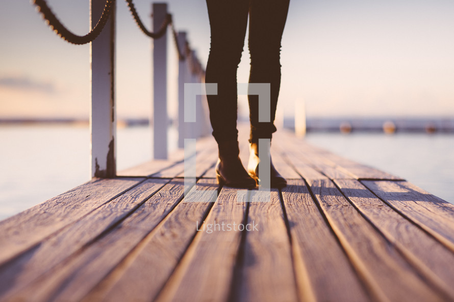 woman standing on a pier 