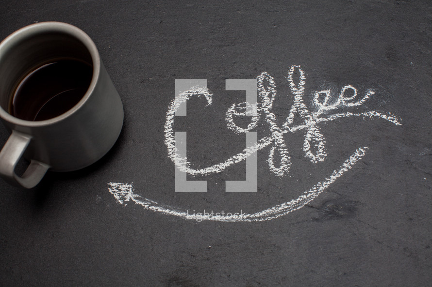 word coffee and arrow pointing to a coffee mug in chalk 