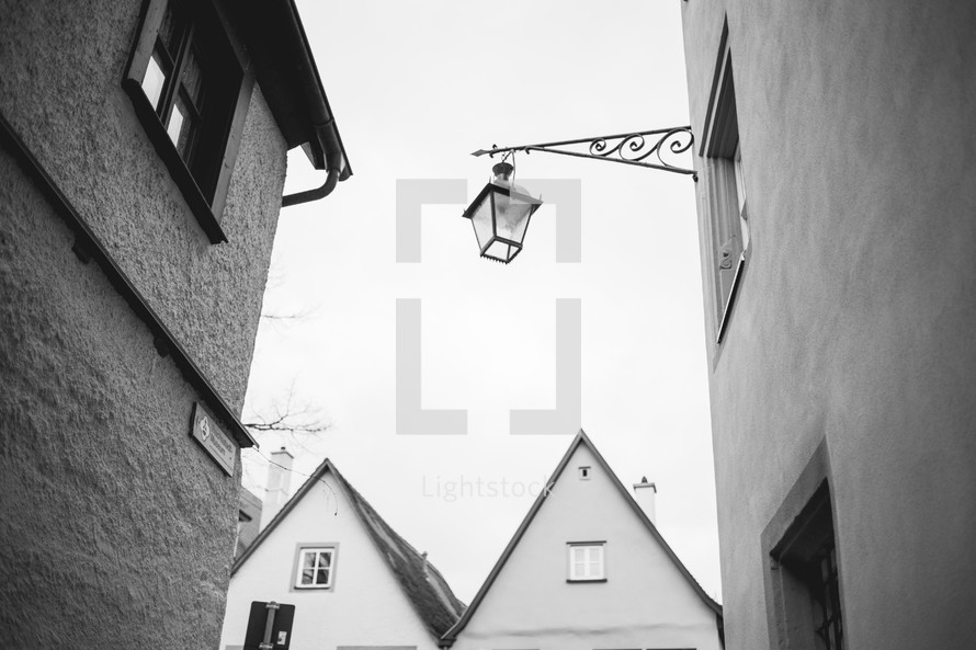 lantern on the side of a house in a European village 