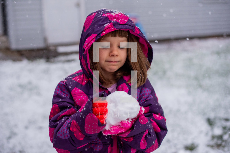Little girl playing in the snow
