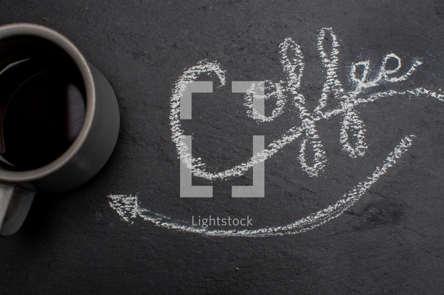 word coffee in chalk and an arrow pointing to a coffee mug 