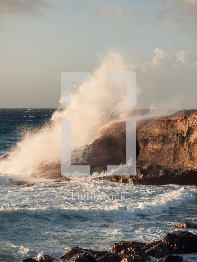 Sea waves crash into the rock