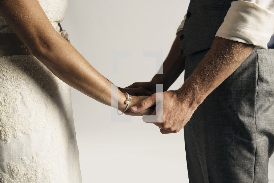 bride and groom holding hands 