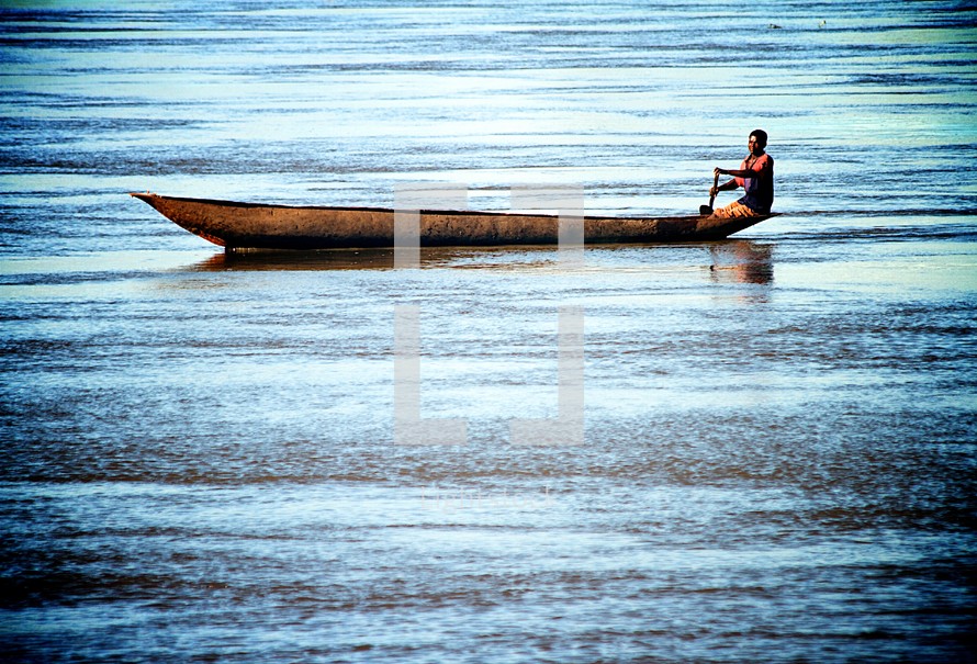 man paddling a boat 