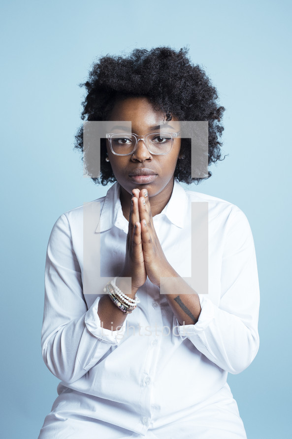 young African American female model with hands in prayer 