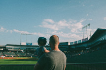 father and son watching a baseball game 