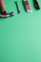 Tools lined up at the top of a green background.