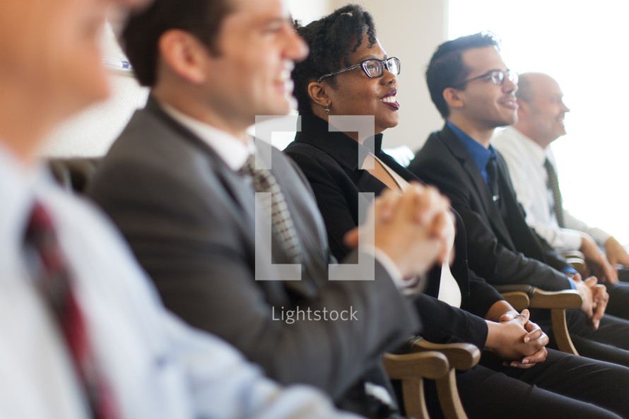 men and women listening to a business meeting 