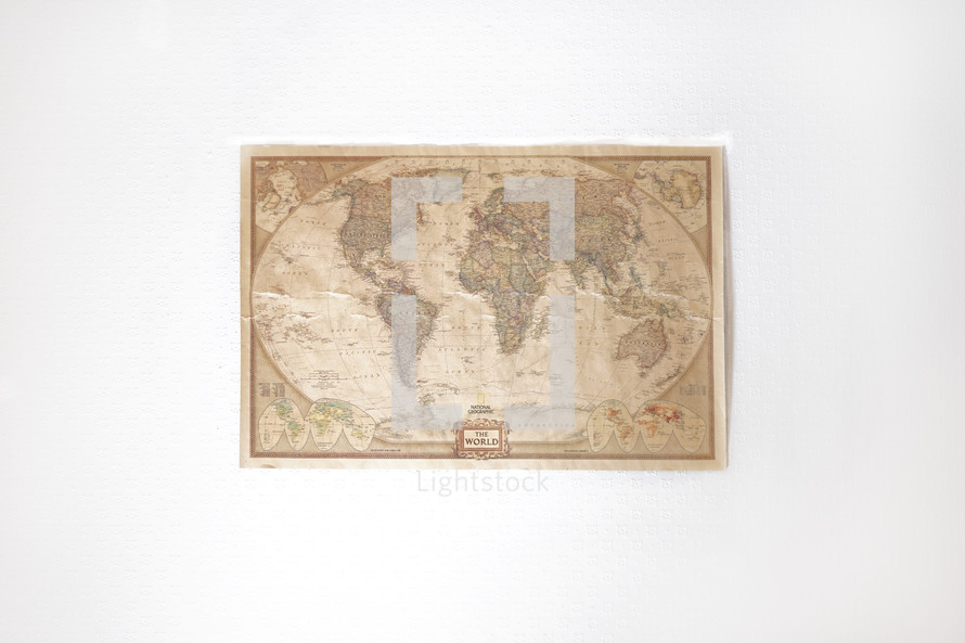 a world map hanging on a wall 
