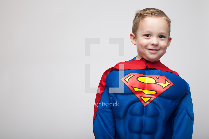 a boy child in a superman costume 
