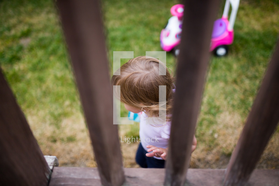 toddler girl playing outdoors 