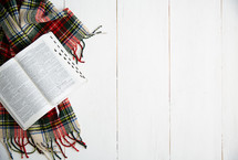 open Bible on a plaid scarf 