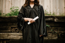 female graduate holding a diploma 