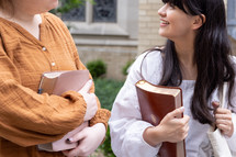 two women holding Bibles 