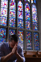 a man praying alone in church 