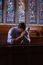 a man praying in a church 