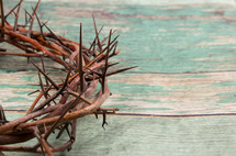 crown of thorns on a green wood background 