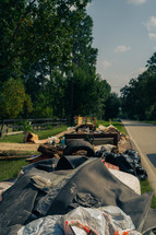 Debris on the side of a road, cleaning up after a flood 