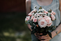 woman holding a bouquet of flowers 