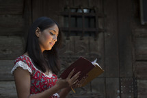 woman with face glowing reading a Bible