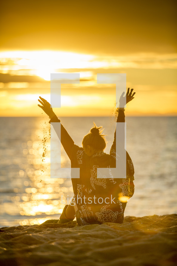 woman playing with sand at a beach 