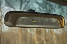 Arrow sign in rear view mirror