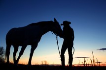 silhouette of a cowgirl and her horse 