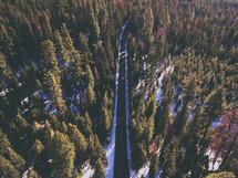 Aerial view over a highway lined with snow 