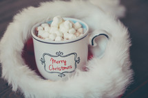 marshmallows in hot cocoa in a santa hat 