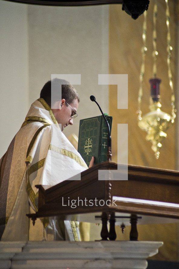 priest at the pulpit presenting the gospel 