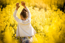 a girl in a field of yellow flowers 