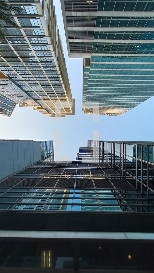 looking up between tall city buildings 