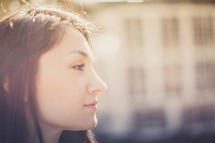 A young woman looking off into the sunlight