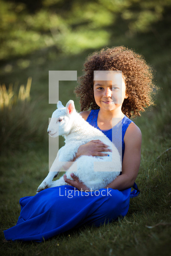 a child holding a lamb