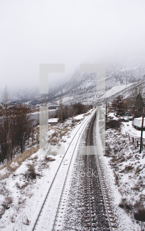 snow covered train tracks 