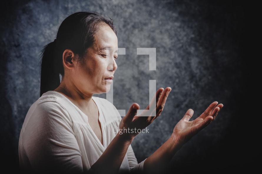 Asian woman praying to God