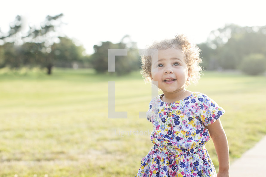 smiling toddler girl outdoors 