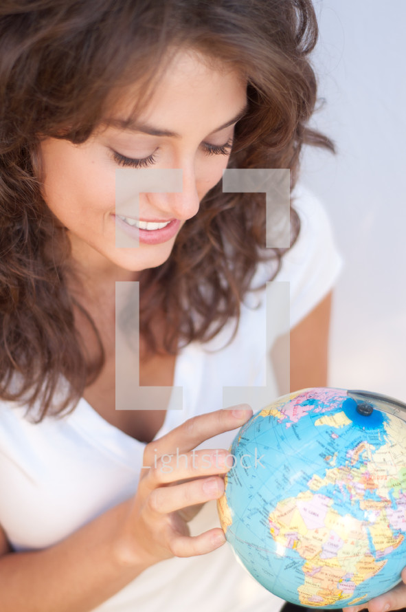 woman holding a globe