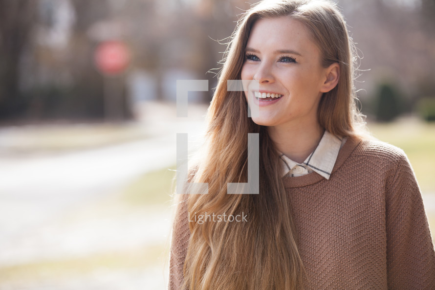 headshot of a smiling woman outdoors 