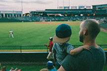 father and son watching a baseball game 
